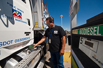 Photo of truck driver filling his vehicle’s tank at biodiesel fueling station