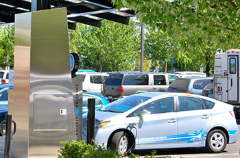 Photo of plug-in hybrid electric vehicle at electric charging station